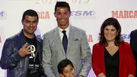 Real Madrid's striker Cristiano Ronaldo poses with his mother Dolores Aveiro (R), his son Cristiano Ronaldo Jr (C) and his brother Hugo (L) in front of his four Golden Boot trophies during a ceremony in Madrid, Spain, October 13, 2015. REUTERS/Andrea Coma