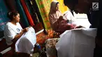 Perajin membuat pola batik bunga anggrek khas Tangerang Selatan pada kain di tempat pembuatan batik kawasan Pamulang, Minggu (21/10). Batik Tangsel ini sudah menembus pasar dunia seperti Makao, Kamboja, China, Hanoi dan Bangkok. (Merdeka.com/Arie Basuki)