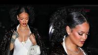 Rihanna mengenakan gaun putih mini dibalut mantel cokelat buaya di pesta makan malam ulang tahunnya yang ke-35. (Dok. Instagram/@favrobz/https://www.instagram.com/p/Co8BsU7Mmm-/)