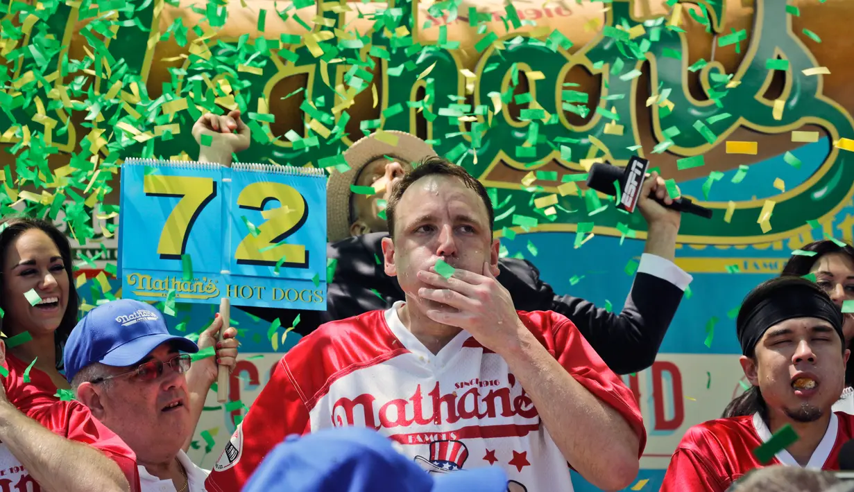 Ekspresi Joey Chestnut merayakan kemenangan dalam Kontes Makan Internasional Nathan, di New York, AS (4/7). Joey Chestnut menang dengan menghabiskan 72 hot dog dalam 10 menit. (AP Photo/Bebeto Matthews)