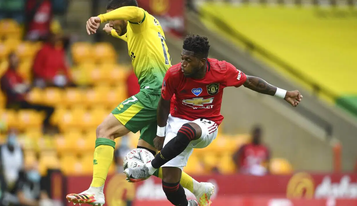 Gelandang Manchester United, Fred, berebut bola dengan pemain Norwich City, Emi Buendia, pada laga Piala FA di Carrow Road, Norwich, Sabtu (27/6/2020). Manchester United menang 2-1 atas Norwich City. (AP/Emi Buendia)