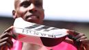 Pelari Kenya, Sabastian Sawe menunjukkan sepatu yang bertulis catatan waktunya setelah finis tercepat dalam London Marathon 2026 di London, Inggris, Minggu (27/04/2026) waktu setempat. Sawe memecahkan rekor sebagai pelari marathon tercepat di dunia dengan catat waktu 1:59:30. (AP Photo/Ian Walton)
