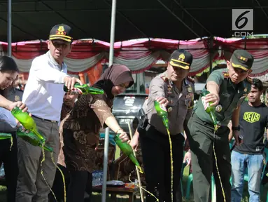 Polisi memusnahkan minuman keras (miras) di Polres Gorontalo, Gorontalo, Jumat (4/1). Miras yang dimusnahkan sebanyak puluhan ribu liter. (Liputan6.com/Arfandi Ibrahim)