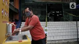Pengunjung mencuci tangan sebelum memasuki pasar tradisional di Jakarta, Senin (15/6/2020). PD Pasar Jaya mulai hari ini memberlakukan penerapan ganjil genap di pasar tradisional sebagai upaya membatasi jumlah pengunjung selama masa PSBB transisi. (merdeka.com/Iqbal S. Nugroho)