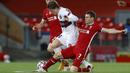 Gelandang Liverpool, James Milner, berebut bola dengan gelandang Midtjylland, Anders Dreyer, pada laga Liga Champions 2020/2021 di Stadion Anfield, Rabu (28/10/2020) dini hari WIB. Liverpool menang 2-0 atas Midtjylland. (AFP/Phil Noble/pool)