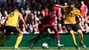 Striker Liverpool, Divock Origi, menggiring bola saat melawan Wolverhampton pada laga Liga Inggris di Stadion Anfield, Liverpool, Minggu (12/5). Liverpool menang 2-0 atas Wolves. (AFP/Paul Ellis)