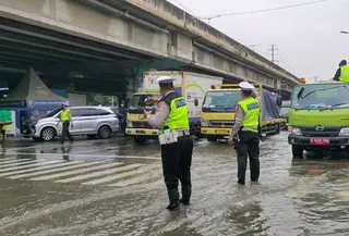 Polisi rekayasa lalu lintas imbas banjir di kolong Ring Road Puri Kembangan, Jakarta Barat yang memicu kemacetan parah lalu lintas di kawasan tersebut, Selasa (4/5/2026). (Antara)
