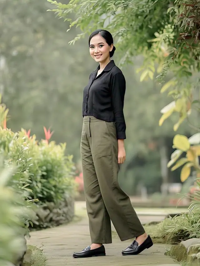 Model wanita memakai kemeja hitam dengan celana kulot olive/Meta AI