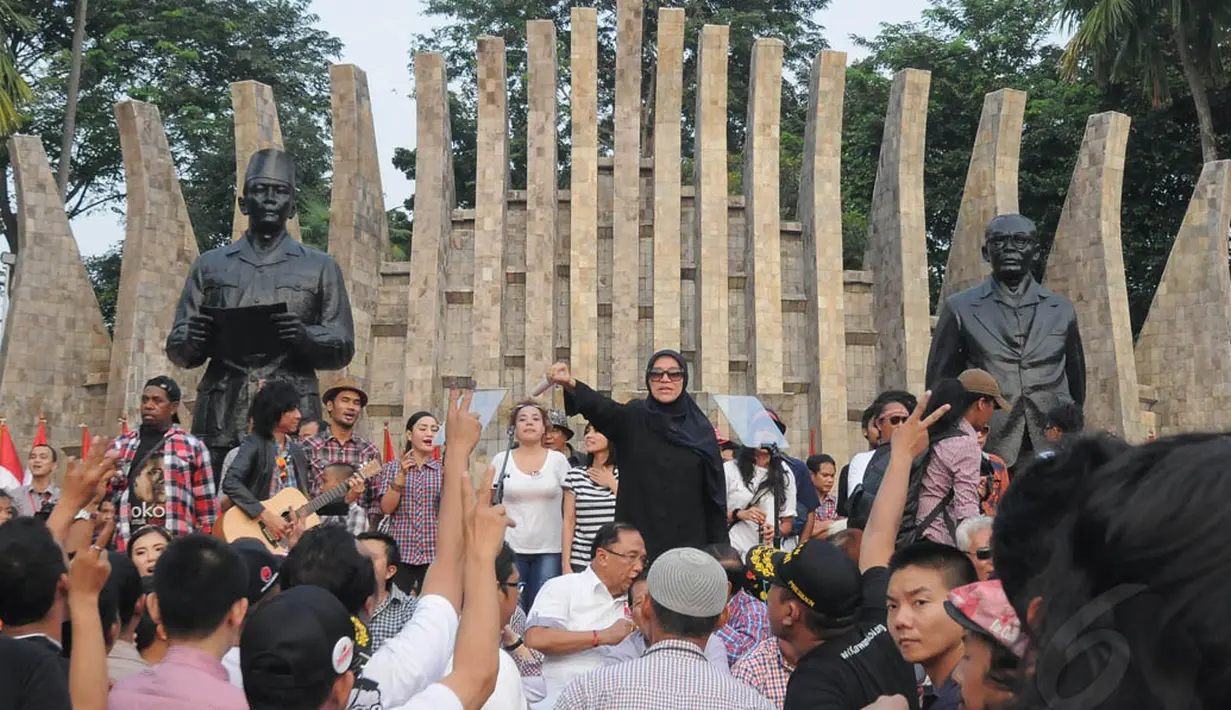 Artis serbabisa, Dorce Gamalama terlihat mengajak relawan bernyanyi bersama lagu "Salam Dua Jari" di Tugu Proklamasi, Jakarta, Rabu (9/7/14). (Liputan6.com/Herman Zakharia)