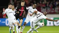 Pemain Bayer Leverkusen, Florian Wirtz berusaha melewati pemain Qarabag FK di pada laga Liga Europa di BayArena, Jumat (27/10/2023). Bayer Leverkusen menang dengan skor telak 5-1. (AP Photo/Martin Meissner)