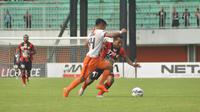 Penyerang sayap Persipura Jayapura, Ferinando Pahabol berduel dengan pemain sayap Pusamania Borneo FC, Arpani dalam lanjutan babak 8 besar Grup E Piala Jenderal Sudirman di Stadion Maguwoharjo, Sleman, Sabtu (19/12/2015). (Bola.com/Romi Syahputra) 