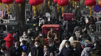 Seorang pengemudi becak melewati jalan yang ramai di Danau Houhai yang membeku di Beijing, Senin (30/1/2023). Orang-orang China menikmati Tahun Baru Imlek dan mengunjungi berbagai lokasi wisata di kota-kota di sekitar China setelah pencabutan pembatasan COVID-19 yang kejam bulan lalu, memungkinkan banyak aspek kehidupan normal kembali. (AP Photo/Andy Wong)