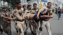 Petugas kepolisian menahan seorang demonstran saat aksi unjuk rasa yang menuntut pengunduran diri Ketua Komisi Pemilihan Umum India, Gyanesh Kumar, di New Delhi, India, Minggu (11/10/2026). (AP Photo/Prabhat Mehrota)