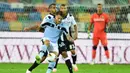 Penyerang Lazio, Ciro Immobile, berebut bola dengan bek Udinese, Rodrigo Becao, pada laga lanjutan Serie A pekan ke-33 di Dacia Arena, Kamis (16/7/2020) dini hari WIB. Lazio bermain imbang 0-0 atas Udinese. (AFP/Miguel Medina)