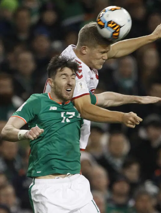 Duel pemain Irelandia, Stephen Ward (kiri) dan pemain Denmark, Peter Ankersen pada laga leg kedua kualifikasi Piala Dunia 2018 di Aviva Stadium, Dublin, (14/11/2017). Denmark menang 5-1. (AP/Peter Morrison)