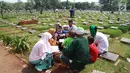 Warga berdoa saat berziarah di TPU Karet Pasar Baru Barat, Jakarta, Sabtu (16/6). Ziarah kubur atau "nyekar" pada hari raya lebaran merupakan salah satu tradisi umat muslim untuk mendoakan sanak keluarga yang meninggal dunia. (Liputan6.com/Arya Manggala)