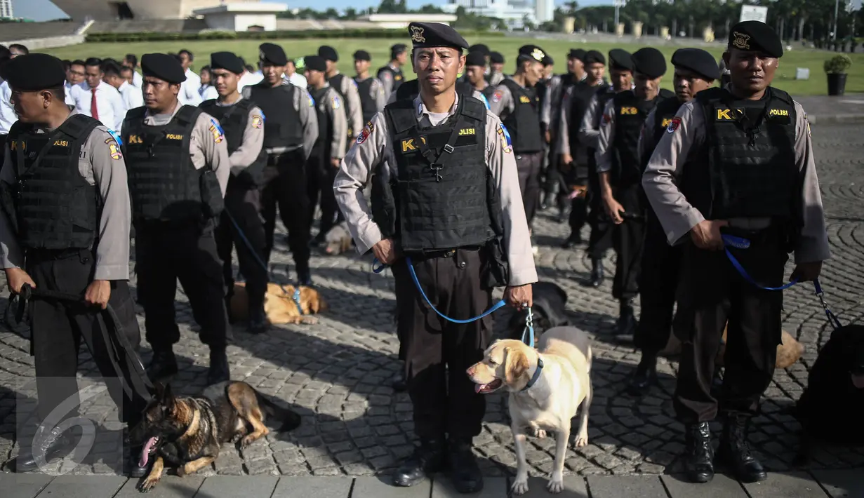 Anggota Unit K-9 dengan anjing pelacak mengikuti Apel Gelar Pasukan Operasi Lilin Jaya 2017 di Lapangan Silang Monas, Jakarta, Kamis (22/12). Apel ini dipimpin oleh Kapolri Jenderal Tito Karnavian selaku Inspektur Upacara. (Liputan6.com/Faizal Fanani)
