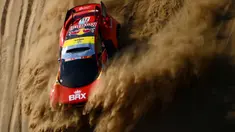 Pembalap Prancis, Sebastien Loeb dan co-driver Fabian Lurquin dari Belgia bersaing selama Stage 1A Reli Dakar 2022 antara Jeddah dan Hail, di Arab Saudi, pada 1 Januari 2022.
(AFP/Franck Fife)
