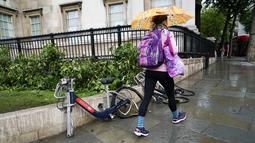 Seorang wanita berjalan melewati dua sepeda sewaan yang dirusak di Trafalgar Square, London, setelah Italia mengalahkan Inggris dalam perebutan gelar juara EURO 2020, pada Senin (12/7/2021). Usai pertandingan, jalan-jalan di London juga dipenuhi sampah. (AP Photo/Alberto Pezzali)