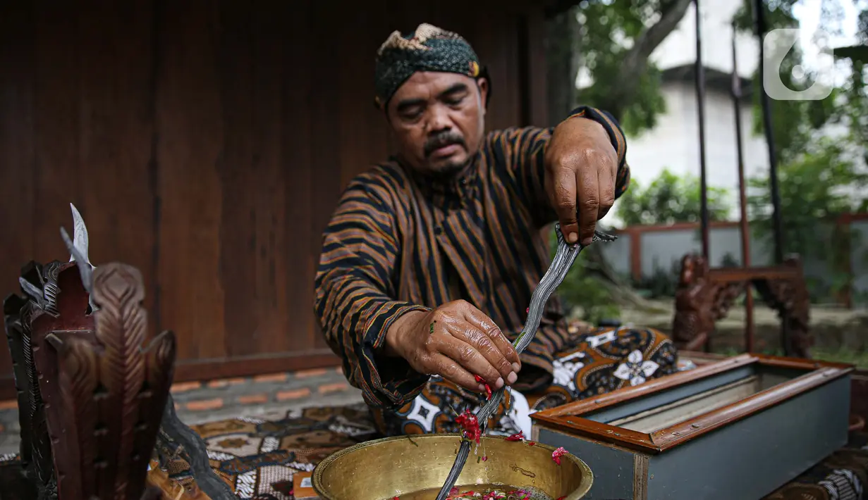 Nasip Hadi Prayitno (51) melakukan ritual jamasan atau pencucian keris di Museum Pusaka TMII, Jakarta, Kamis (20/8/2020). Ritual yang dilakukan setiap memasuki bulan Muharam merupakan upaya mempertahankan keutuhan keris sebagai warisan budaya leluhur yang diakui UNESCO.  (Liputan6.com/Faizal Fanani)