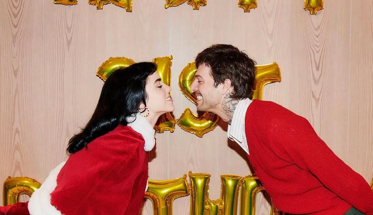 Ia tampil memesona dengan korset merah yang memiliki trim putih. Persis seperti Santa Claus. [instagram/billieeilish]