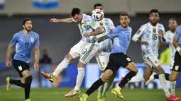 Bek Argentina, Nicolas Tagliafico (3) menyudul bola dibayangi gelandang Uruguay, Matias Vecino pada laga Kualifikasi Piala Dunia 2022 Zona Amerika Selatan di Monumental stadium, Senin (11/10/2021) pagi WIB. Argentina melibas Uruguay dengan skor 3-0. (AP Photo/Gustavo Garello)