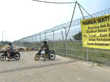 Pengendara sepeda motor berputar arah saat Jalan Perimeter Utara diblokir warga, Rawa Rengas, Kosambi, Tangerang, Banten, Selasa (2/7/2019). Warga memblokir akses menuju Bandara Soekarno-Hatta (Soetta) tersebut karena belum dibayarnya ganti rugi tanah dan bangunan. (merdeka.com/Arie Basuki)