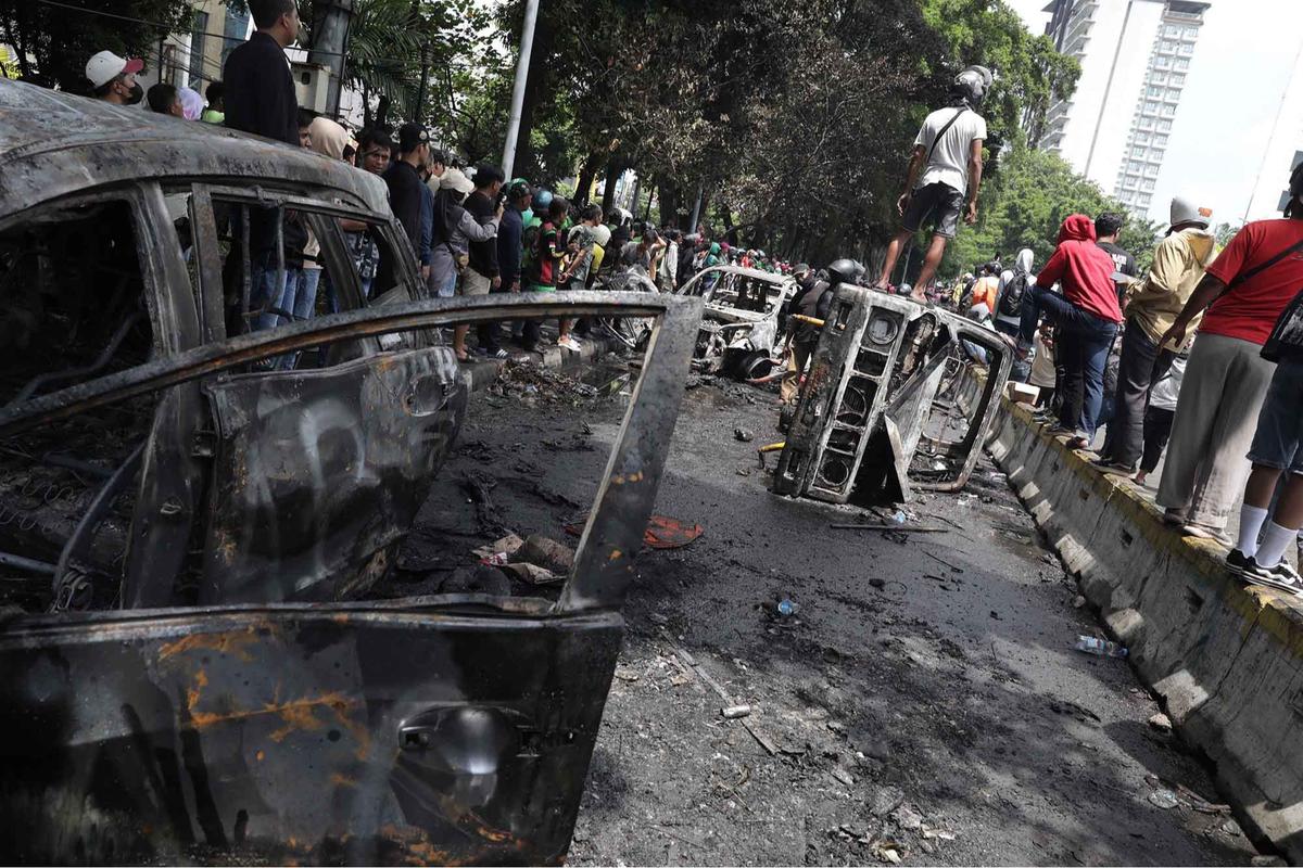 FOTO: Warga Ambil Bangkai Mobil Usai 10 Kendaraan Dibakar di Depan Mako Brimob Kwitang