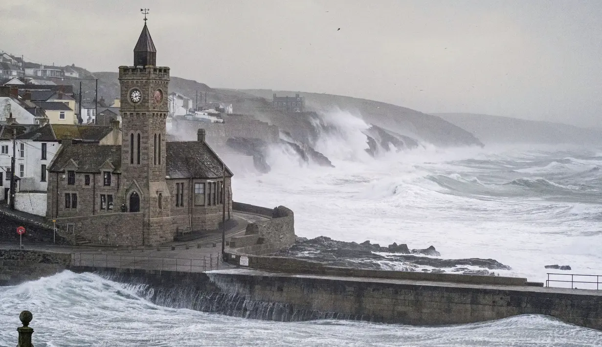 Ombak menghantam Porthleven saat Badai Eunice mendarat di pantai Cornish, Inggris, Jumat (18/2/2022). Badai besar kedua minggu ini memicu peringatan cuaca "merah" yang langka di seluruh Inggris selatan. (Matt Keeble/PA via AP)