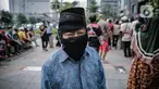 Warga antre makanan gratis di kawasan Sudirman, Jakarta, Jumat (8/5/2020). Bagi-bagi makanan ini dilakukan sebagai bentuk kepedulian untuk pengemudi ojol dan warga sekitar yang terdampak kebijakan penanganan virus corona, seperti work frome home dan physical distancing. (Liputan6.com/Faizal Fanani)