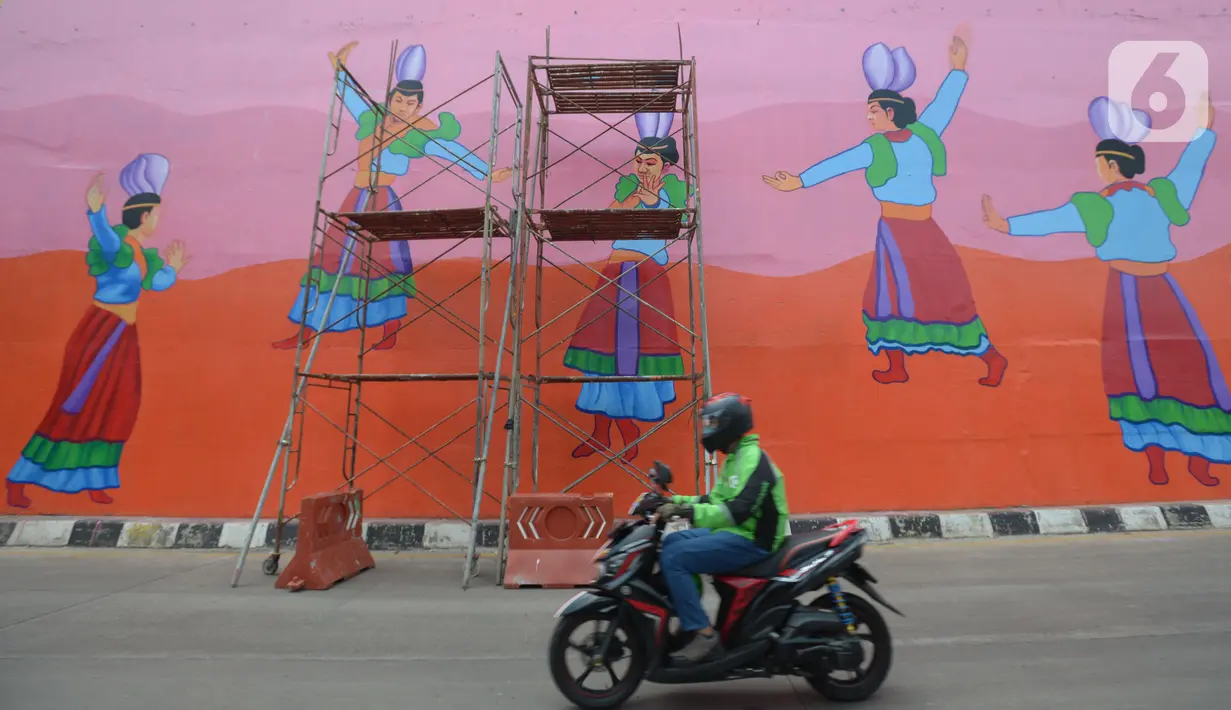 Pengendara motor melintas di Flyover 'Gaplek' Martadinata yang dipercantik dengan lukisan mural di Tangerang Selatan, Jumat (9/4/2021). Seni mural ini untuk memperindah suasana jalan kota. (merdeka.com/Imam Buhori)