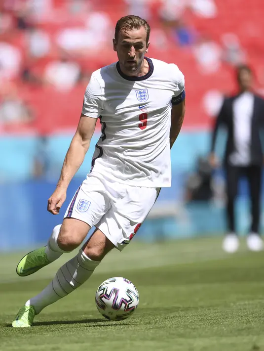 Penyerang Inggris, Harry Kane membawa bola saat bertanding melawan Inggris pada pertandingan grup D Euro 2020 di stadion Wembley di London, Minggu (13/6/2021). Inggris menang tipis atas Kroasia dengan skor 1-0. (Laurence Griffiths, Pool via AP)