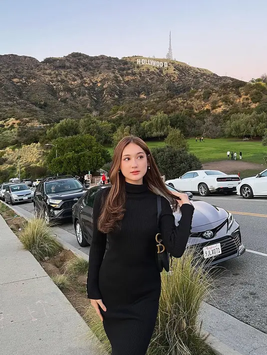 Laura Moane tampil cantik dengan knitted turtleneck dress lengan panjang berwarna hitam. Ia padukan penampilannya dengan simpel mengenakan tas yang juga berwarna hitam. [Foto: Instagram/its_lauramoane2]