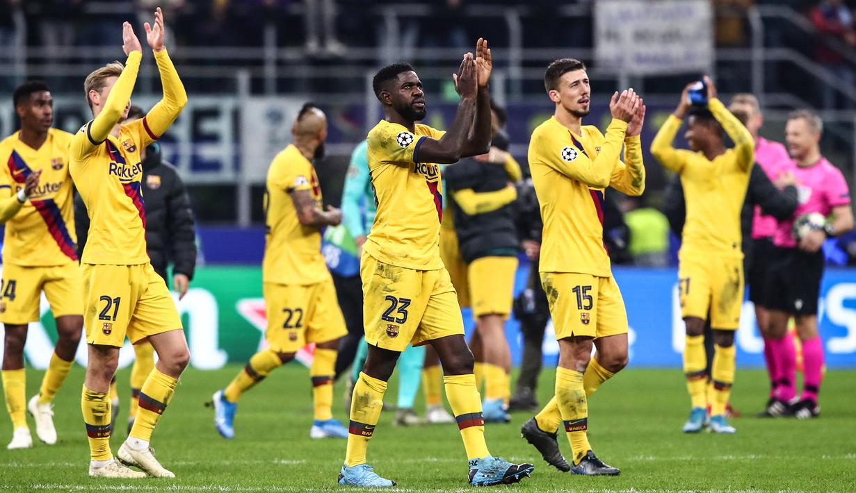 Para pemain Barcelona merayakan kemenangan atas Inter Milan pada laga Liga Champions di Stadion San Siro, Milan, Selasa (10/12). Inter kalah 1-2 dari Barcelona. (AFP/Isabella Bonotto)