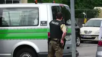 Polisi berjaga di luar pusat perbelanjaan Olympia di Munich, Jerman (22/7). Kepolisian menyatakan penembakan di pusat perbelanjaan tersebut dilakukan oleh seorang remaja blasteran Jerman-Iran berusia 18 tahun. (dedinac/Marc Mueller/REUTERS)