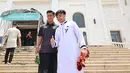 Dua pemain Timnas Indonesia U-22, Ernando Ari Sutaryadi (kanan) dan Pratama Arhan berfoto saat tiba di depan Masjid Al Serkal, Phnom Penh, Kamboja, Jumat (5/5/2023) untuk melaksanakan ibadah Salat Jumat di sela-sela SEA Games 2023 Kamboja. (Bola.com/Abdul Aziz)