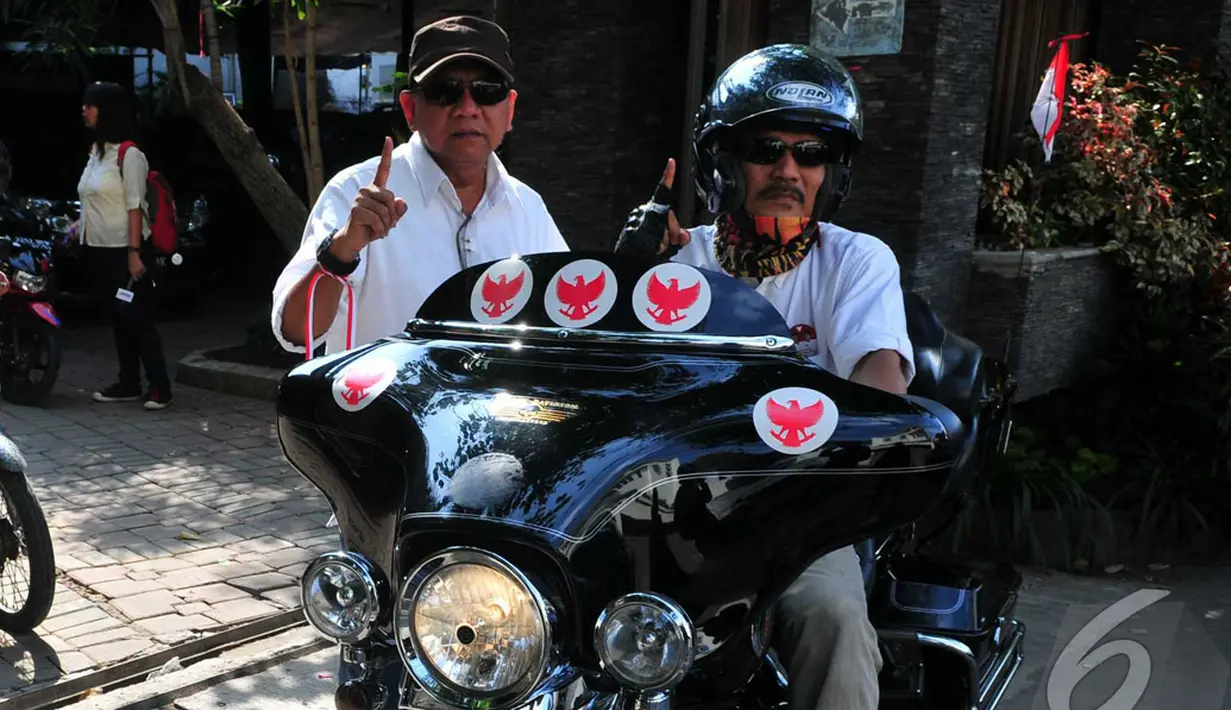 Salah seorang peserta konvoi menunjukkan salam satu jari sambil menaiki motor besarnya, Jakarta, Kamis (10/9/2014) (Liputan6.com/Johan Tallo)