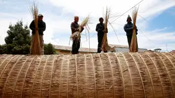 Para pekerja sedang menyelesaikan pembuatan perahu 'Viracocha III' di kota La Paz Bolivia, Rabu (19/10). Dalam kepercayaan Inca, Viracocha adalah salah satu nama dewa yang menciptakan kehidupan. (Reuters/David Mercado)