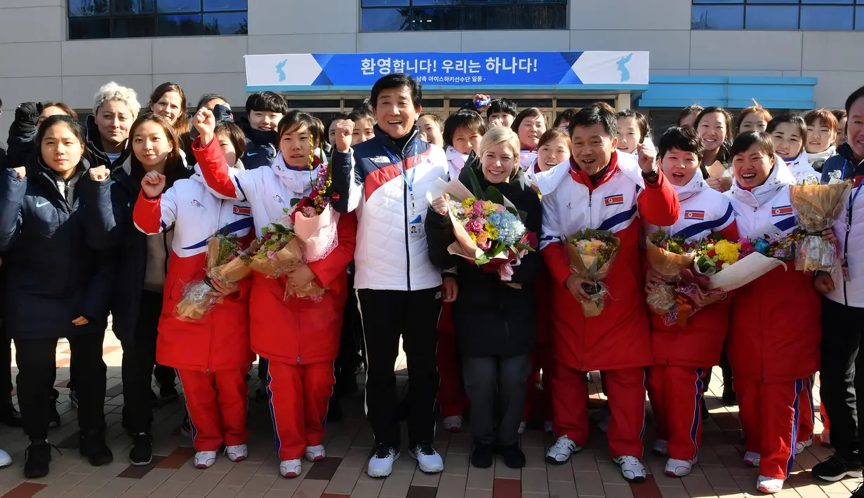Tim hoki es Korea Utara berfoto bersama tim Korea Selatan di pusat pelatihan nasional Jincheon, Korsel (25/1). Tim hoki es dari Korut ini akan mengkuti olimpede musim dingin bersama tim Korea Selatan sebagai tim gabungan. (AFP Photo/Pool/ Kyung-Seok)