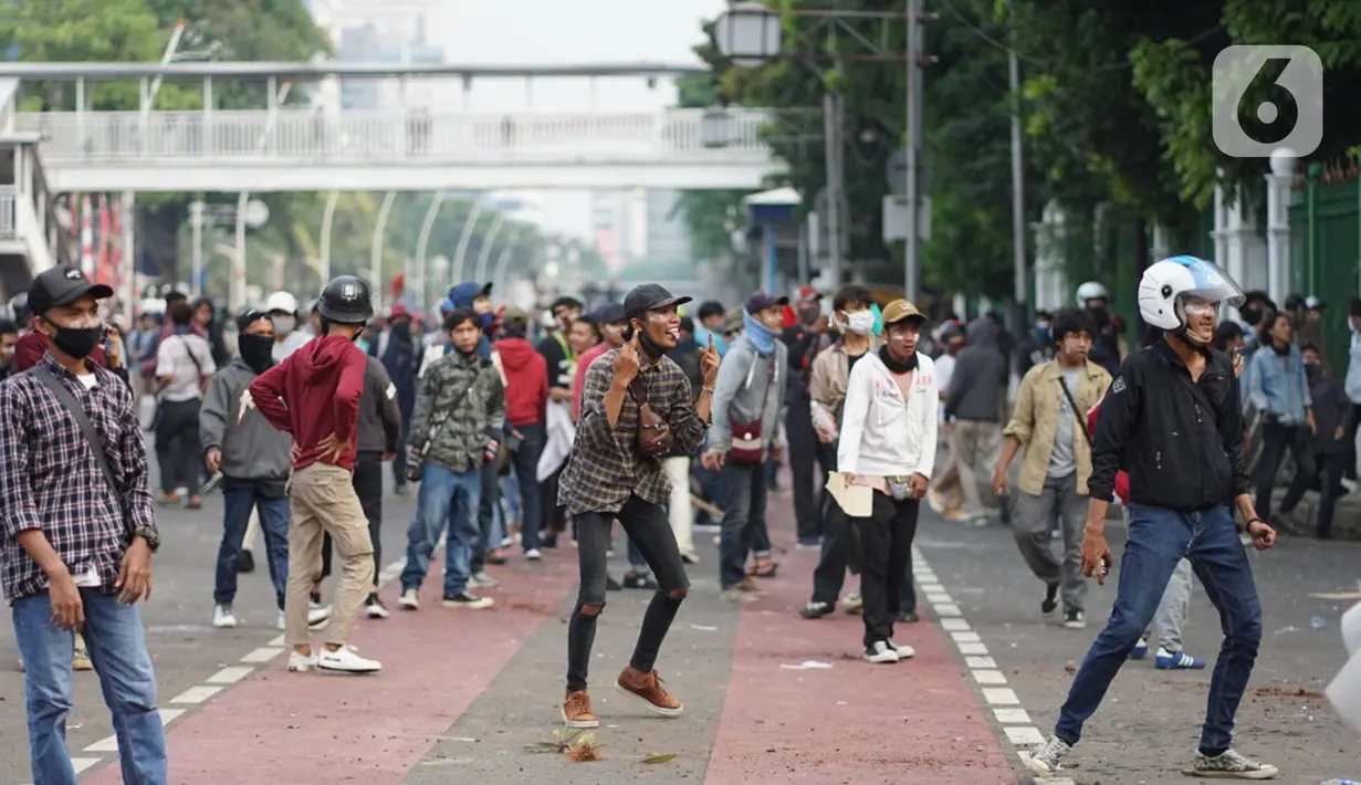 Pengunjuk rasa terlibat bentrok dengan polisi di Jalan Medan Merdeka Timur, Jakarta, Kamis (8/10/2020). Bentrokan terjadi akibat massa yang memaksa masuk ke depan Istana Negara untuk berunjuk rasa terkait penolakan UU Cipta Kerja. (Liputan6.com/Immanuel Antonius)