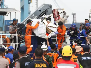 Petugas menurunkan sejumlah barang temuan yang diduga milik penumpang pesawat Lion Air JT 610 di Pelabuhan JICT 2, Jakarta, Selasa (30/10). Sejumlah barang ditemukan petugas gabungan dalam operasi pencarian. (Liputan6.com/Helmi Fithriansyah)
