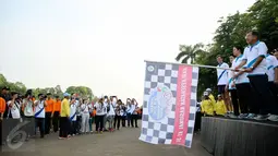 Wakil Presiden Jusuf Kalla memegang bendera tanda dimulainya jalan sehat  memperingati puncak Hari Kesehatan Nasional Ke-51 di Silang Monas, Jakarta, Minggu (6/12/2015). Acara tersebut dihadiri sebanyak 2000 peserta. (Liputan6.com/Faizal Fanani)