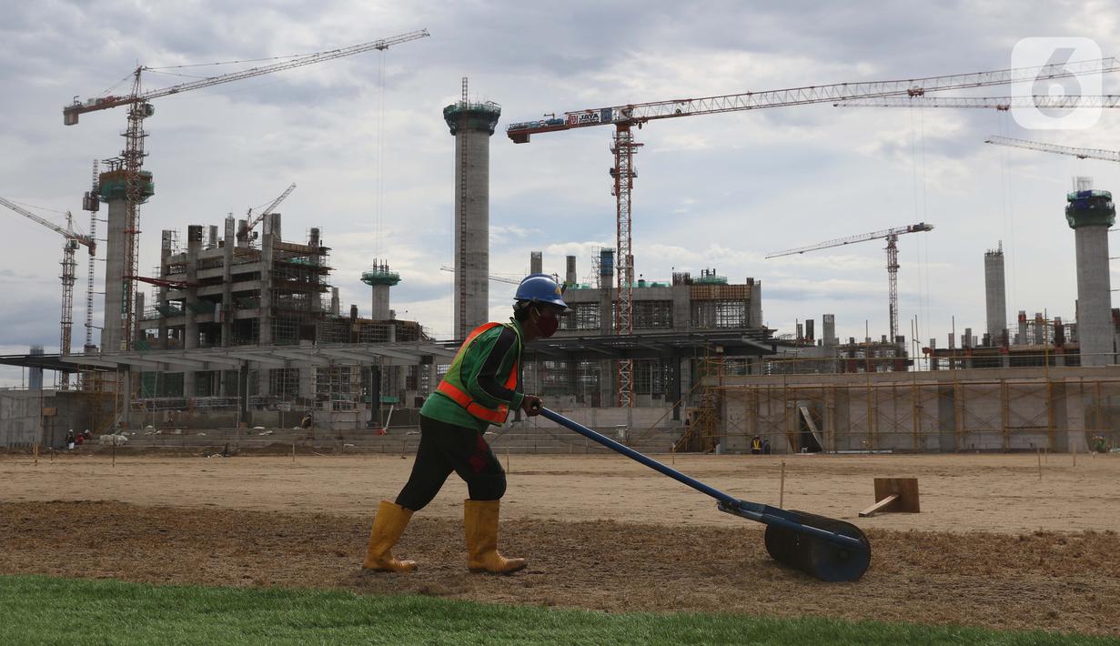 Pekerja melakukan perataan tanah di area lapangan latih Jakarta International Stadium, Jumat (23/10/2020). Nantinya lapangan latihan ini akan ditumbuhi rumput hybrid, yang memiliki komposisi 5 persen rumput sintetis dan 95 persen natural berjenis Zoysia Matrella. (Liputan6.com/Helmi Fithriansyah)