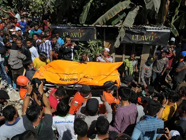 Petugas gabungan saat mengevakuasi korban  menyusul gempa 6,4 SR di Kabupaten Pidie Jaya, Aceh, Rabu (7/12). BPBD Pidie Jaya, Puteh Abdul Manaf mencatat korban jiwa gempa Aceh berdasarkan data sementara sebanyak 28 orang. (AFP PHOTO/Chaideer Mahyuddin)