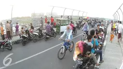 Antusias warga Palimanan untuk melihat Lawan Arus di Tol Palimanan, Cirebon, Jawa Barat (9/7). Libur Lebaran dimanfaatkan warga sekitar untuk melihat arus mudik. (Liputan6.com/Herman Zakharia)