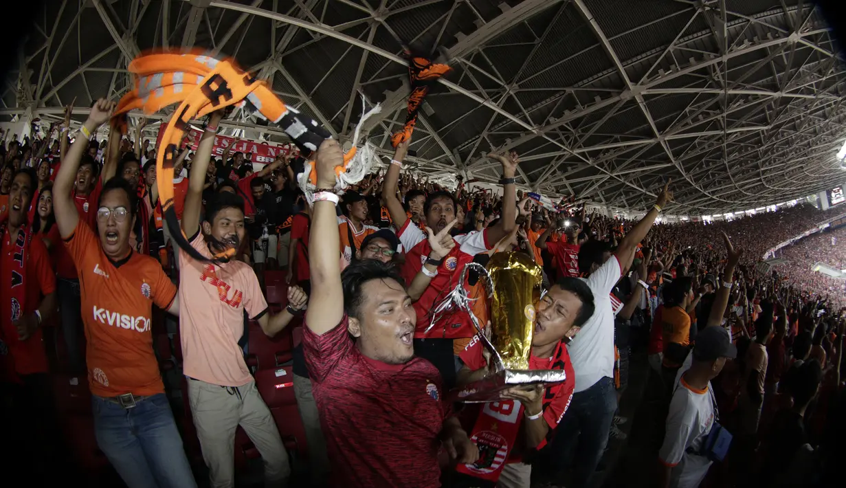 Suporter Persija Jakarta merayakan gelar juara Liga 1 di SUGBK, Jakarta, Minggu (09/12). Persija menang 2-1 atas Mitra Kukar. (Bola.com/M Iqbal Ichsan)