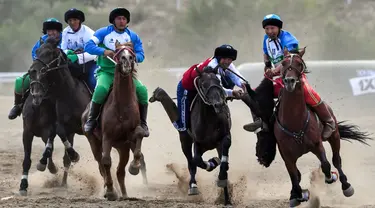 Penunggang kuda dari Uzbekistan (Biru) dan Rusia (Merah) memainkan olahraga tradisional Asia Tengah Kok Boru (Serigala Abu-Abu) atau Buzkashi (Mencengkeram Kambing) saat Piala Dunia Kok Boru di Cholpon-Ata dekat Danau Issyk-Kule, sekitar 250 Km sebelah timur Bishkek, 14 Agustus 2023. Pemain berkuda bersaing untuk mendapatkan poin dengan melempar boneka kulit domba ke dalam sumur. (VYACHESLAV OSELEDKO/AFP)