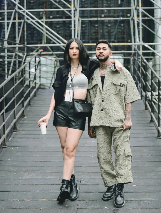 Gaya keren pasutri Onadio dan Beby. Onadio tampil dengan satu set atasan dan bawahan bernuansa hijau, sedangkan Beby tampil mengenakan atasan cropped bra abu-abu ditumpuk dengan jaket kulit hitam yang serasi dengan celana pendek yang dikenakannya. [Foto: Instagram/bebyleonardo]