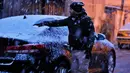 Seorang pria membersihkan salju dari mobilnya di Baghdad, Selasa (11/2/2020). Salju turun di Baghdad untuk pertama kalinya dalam satu dekade setelah sebelumnya ibu kota Irak itu sempat diguyur salju pada 2008, tetapi hanya berlangsung sekejap dan langsung mencair. (AP Photo/Ali Abdul Hassan)