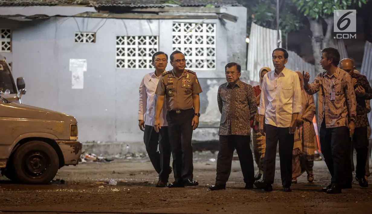 Presiden Jokowi dan Wakil Presiden Jusuf Kalla ketika melihat lokasi ledakan di Terminal Kampung Melayu Kamis (25/5). Jokowi datang ke lokasi kejadian usai menengok korban ledakan yang dirawat di Rumah Sakit Polri Kramat Jati. (Liputan6.com/Faizal Fanani)